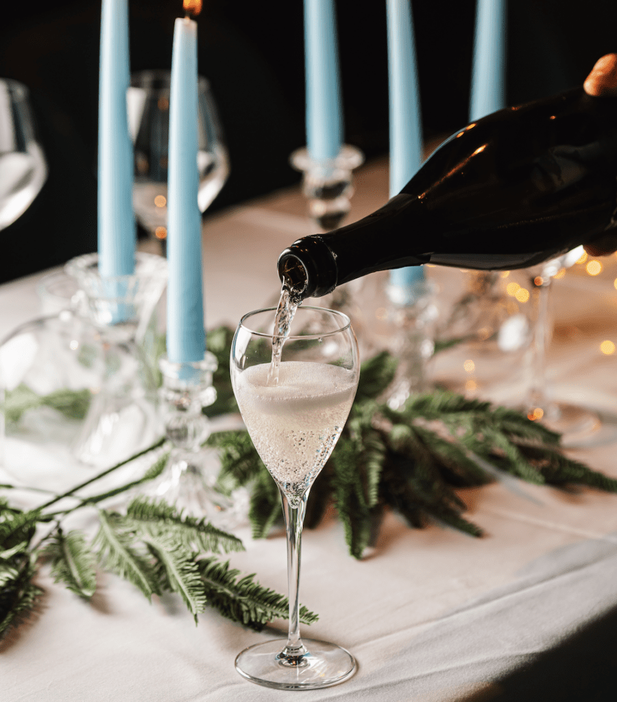 Champagne is being poured on a festive table